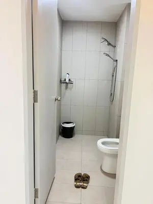 a bathroom with a toilet and a pair of sandals on the floor at Cozy Kenwingston Platz KL 2-5 Pax2BR&2BR PakinNetf 4305A in Kuala Lumpur