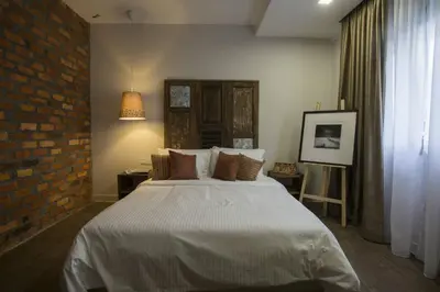 a bedroom with a bed and a brick wall at Redstone Boutique Hotel Kuala Lumpur in Kuala Lumpur
