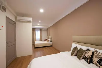 a bedroom with a bed and a couch in a room at Redstone Boutique Hotel Kuala Lumpur in Kuala Lumpur