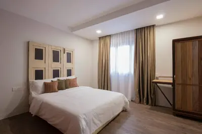 a bedroom with a white bed and a window at Redstone Boutique Hotel Kuala Lumpur in Kuala Lumpur