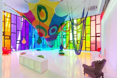 a room with a colorful wall of glass at Gaming World Suite In Arte Mont Kiara in Kuala Lumpur