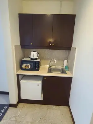 a small kitchen with a sink and a microwave at KL BRB sarvice suite at time square in Kuala Lumpur