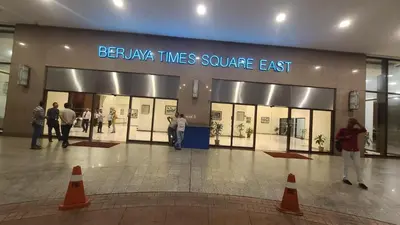 a group of people standing in front of a store at KL BRB sarvice suite at time square in Kuala Lumpur