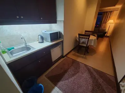 a small kitchen with a sink and a microwave at KL BRB sarvice suite at time square in Kuala Lumpur