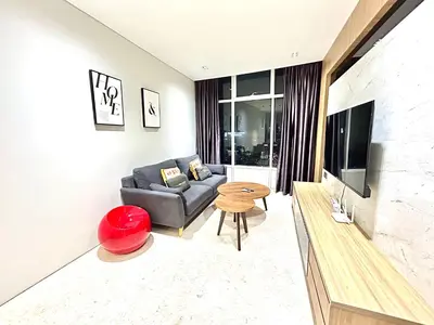 a living room with a couch and a television at Sky Suites KLCC by NADIA in Kuala Lumpur