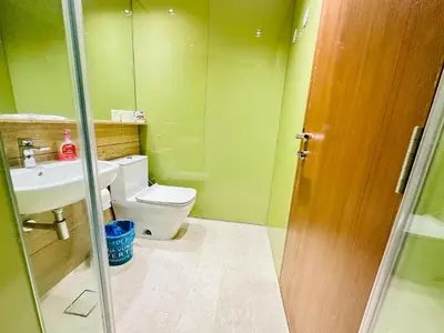 a bathroom with a toilet and a sink at Sky Suites KLCC by NADIA in Kuala Lumpur