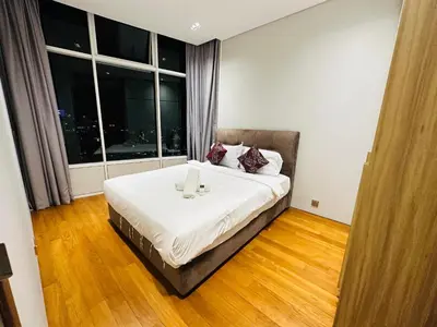 a bedroom with a bed and a large window at Sky Suites KLCC by NADIA in Kuala Lumpur