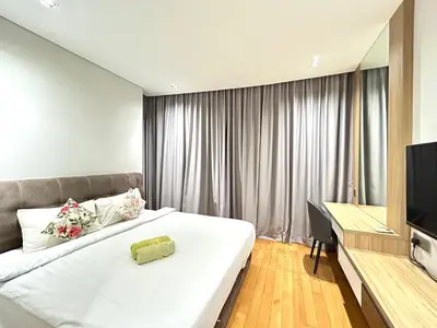 a hotel room with a large bed and a desk at Sky Suites KLCC by NADIA in Kuala Lumpur