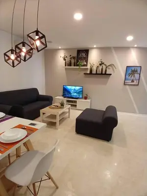 a living room with two couches and a tv at VORTEX SUITS KLCC by MMHB in Kuala Lumpur