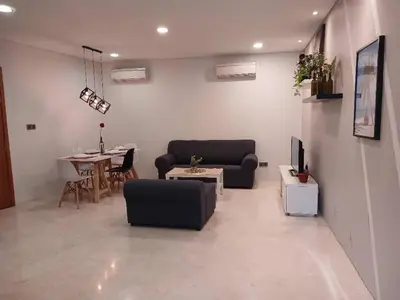 a living room with a couch and a table at VORTEX SUITS KLCC by MMHB in Kuala Lumpur