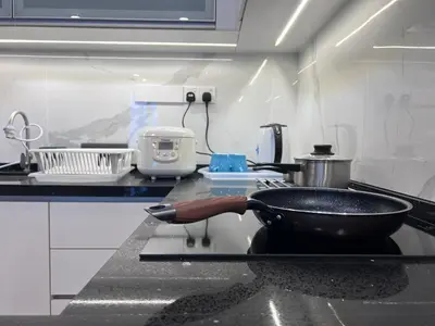 a frying pan on a stove in a kitchen at Societe Hartamas Kuala Lumpur in Kuala Lumpur