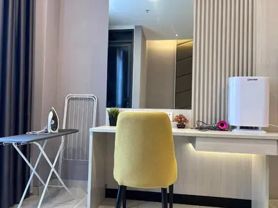 a office with a yellow chair and a desk with a computer at Societe Hartamas Kuala Lumpur in Kuala Lumpur