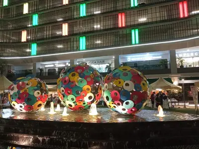 four easter eggs on a table in front of a building at Trion Kuala Lumpur by DSM in Kuala Lumpur