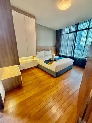 a bedroom with a bed and a large window at Vortex Suites Klcc Area in Kuala Lumpur