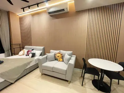 a bedroom with a bed and a chair with a teddy bear at The Pano at Jalan Ipoh Near KLCC By The Homez in Kuala Lumpur