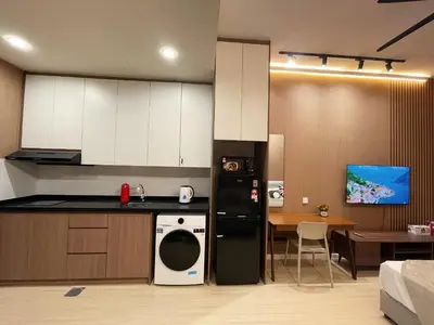 a kitchen with a black and white refrigerator and a table at The Pano at Jalan Ipoh Near KLCC By The Homez in Kuala Lumpur