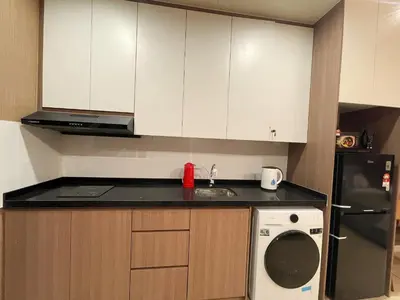 a kitchen with white cabinets and a sink and a dishwasher at The Pano at Jalan Ipoh Near KLCC By The Homez in Kuala Lumpur