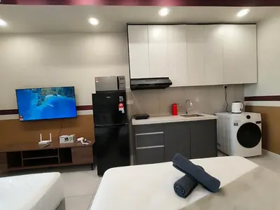 a kitchen with a black refrigerator and a sink at The Pano at Jalan Ipoh Near KLCC By The Homez in Kuala Lumpur