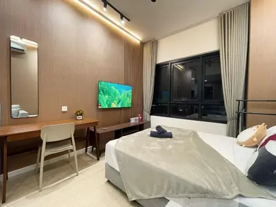 a bedroom with a bed and a desk and a television at The Pano at Jalan Ipoh Near KLCC By The Homez in Kuala Lumpur
