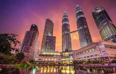 a group of tall buildings in a city at night at Seri Bukit Ceylon Suites Bukit Bintang in Kuala Lumpur