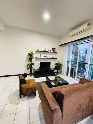 a living room with a couch and a fireplace at Seri Bukit Ceylon Suites Bukit Bintang in Kuala Lumpur