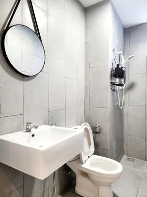 a bathroom with a white sink and a toilet at Cheras MRT KLCC View Home by DefineSuite in Kuala Lumpur