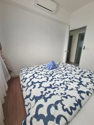 a bedroom with a bed with a blue and white comforter at Cheras MRT KLCC View Home by DefineSuite in Kuala Lumpur