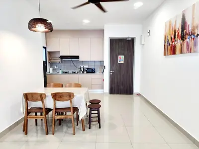 a kitchen and dining room with a table and chairs at Cheras MRT KLCC View Home by DefineSuite in Kuala Lumpur