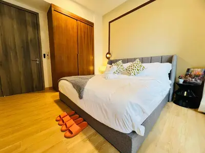 a bedroom with a bed and a pair of shoes on the floor at Agile Bukit Bintang by DeUrban in Kuala Lumpur