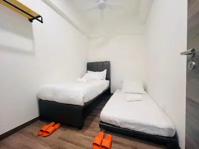two beds in a small room with orange shoes at Agile Bukit Bintang by DeUrban in Kuala Lumpur