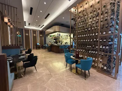 a restaurant with blue chairs and tables and a bar at Star Residence KL in Kuala Lumpur