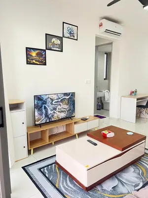 a living room with a table and a tv at Cozy Kenwingston Platz KL 2-5 Pax2BR & 2BR FrePakin Netflix 3803 in Kuala Lumpur