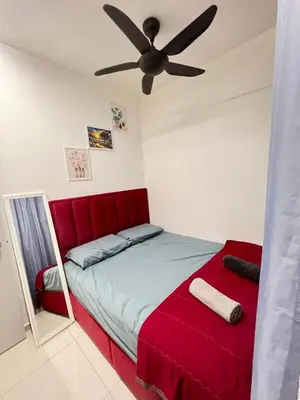 a bedroom with a red bed and a ceiling fan at Cozy Kenwingston Platz KL 2-5 Pax2BR & 2BR FrePakin Netflix 3803 in Kuala Lumpur