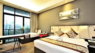 a hotel room with two beds and a large window at M101 Sky Suites at Dang Wangi KLCC in Kuala Lumpur