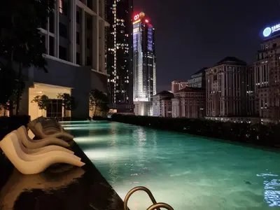 a swimming pool in a city at night at The Mews KLCC, Five Senses in Kuala Lumpur