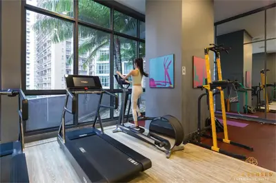 a woman walking on a treadmill in a gym at The Mews KLCC, Five Senses in Kuala Lumpur