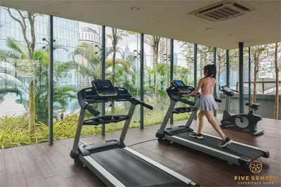 a woman walking on a treadmill in a gym at Dorsett Kuala Lumpur, Five Senses in Kuala Lumpur