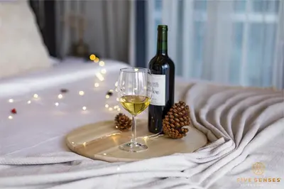 a bottle of wine and a glass on a tray at Dorsett Kuala Lumpur, Five Senses in Kuala Lumpur