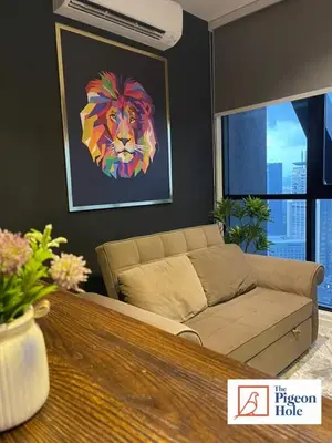 a living room with a couch with a painting of a lion at KLCC Scarletz Executive Suite by ThePigeonHole in Kuala Lumpur