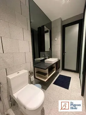 a bathroom with a white toilet and a sink at KLCC Scarletz Executive Suite by ThePigeonHole in Kuala Lumpur