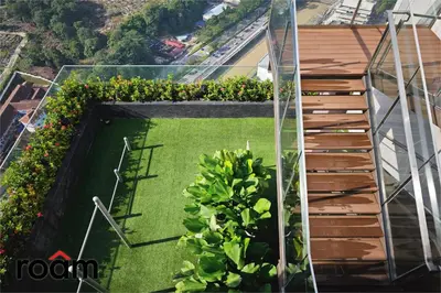 a balcony with a garden on a building at The Riv, Riveria City KL Sentral in Kuala Lumpur