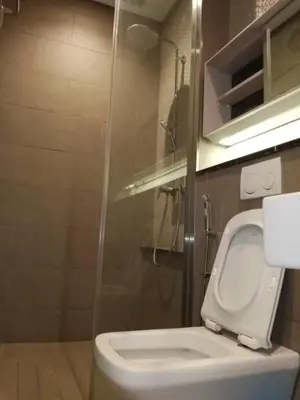 a bathroom with a white toilet and a shower at TS Hotel Service Residence Kuala Lumpur in Kuala Lumpur