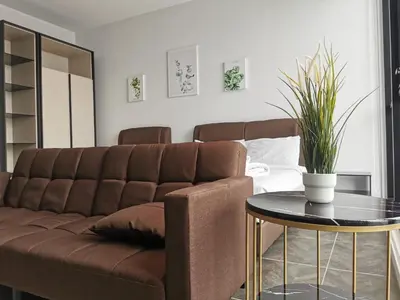 a living room with a couch and a table at Scarletz Suites KLCC by De Harlequins Suite in Kuala Lumpur