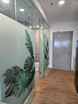 a bathroom with a glass door and a shower at Riveria City by Nomadnest in Kuala Lumpur