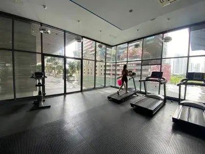 a woman walking on a treadmill in a gym at Cemara Premier Residence Ampang Near KLCC Kuala Lumpur in Kuala Lumpur