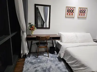 a bedroom with a desk with a bed and a mirror at Cemara Premier Residence Ampang Near KLCC Kuala Lumpur in Kuala Lumpur