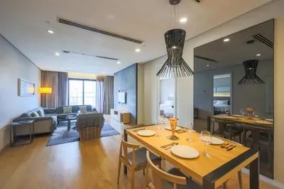 a kitchen and living room with a table and chairs at 188 Suites Kuala Lumpur in Kuala Lumpur