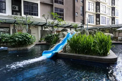a blue water slide in the middle of a fountain at 188 Suites Kuala Lumpur in Kuala Lumpur