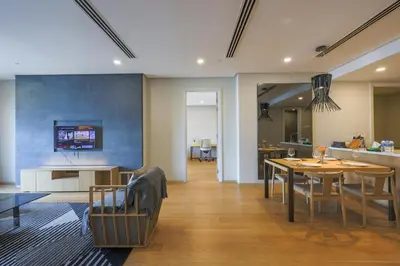 a living room with a table and a dining room at 188 Suites Kuala Lumpur in Kuala Lumpur
