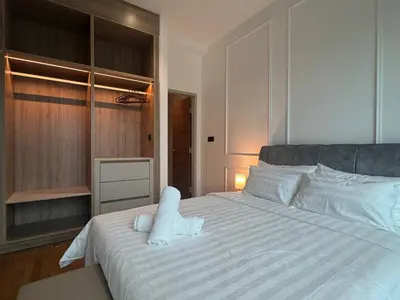 a white bed with white sheets and pillows on it at Alfa Bangsar By Nova Host in Kuala Lumpur
